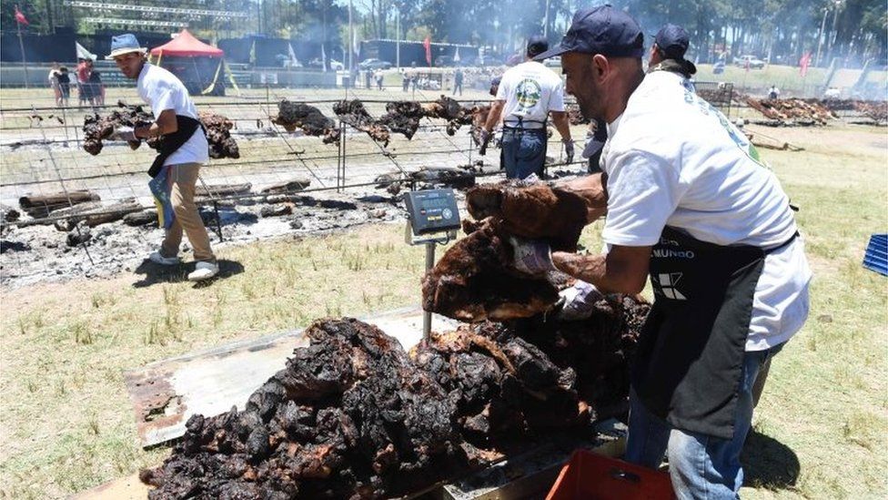 Cooks weigh the beef to reach a total of 16,500 kg, in Rodo Park in Minas, Uruguay, 120 km from Montevideo, in an attempt to break the Guinness record for "The World" s Biggest Barbecue", on December 10, 201