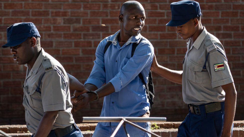 A man is arrested by police officers after resisting orders to vacate a vegetable market area in Bulawayo, Zimbabwe on March 31, 2020