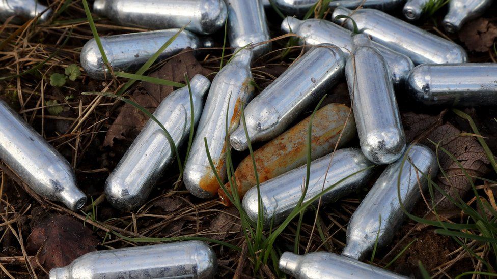 Canisters of nitrous oxide, or laughing gas, discarded by the side of a road