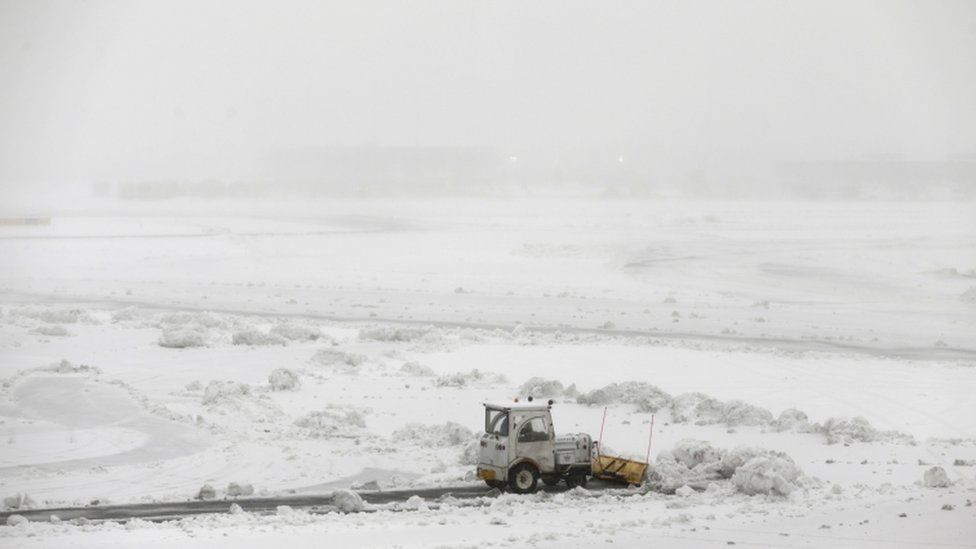 Ploughs work to clear the runways at Newark International Airport