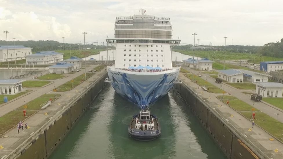 A ship being guided through the Panama Canal