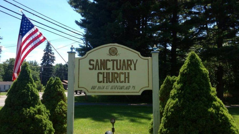 Sign outside church with American flag