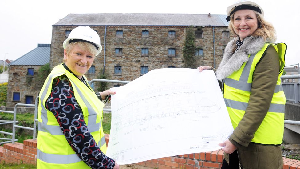 Councillor Linda Evans (left), of Carmarthenshire Council, and Kathryn Edwards, of developers Pobl Group, with the plans