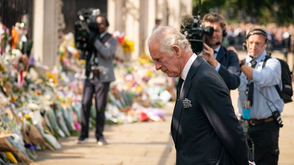 King Charles reads messages left to his mother the late Queen