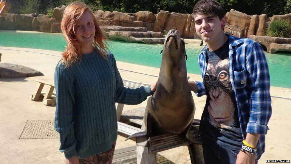Richard and his girlfriend on holiday, pictured next to a seal