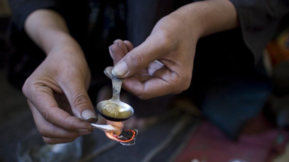 A drug users prepares heorin