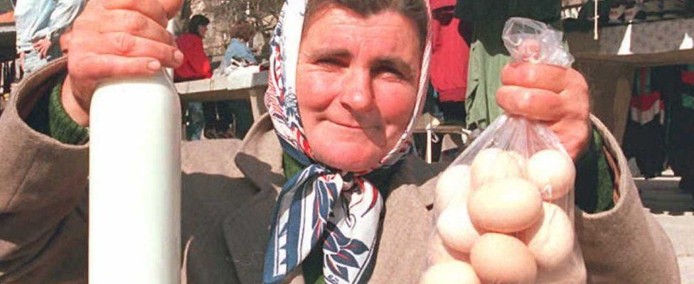 Serb woman holds milk and eggs