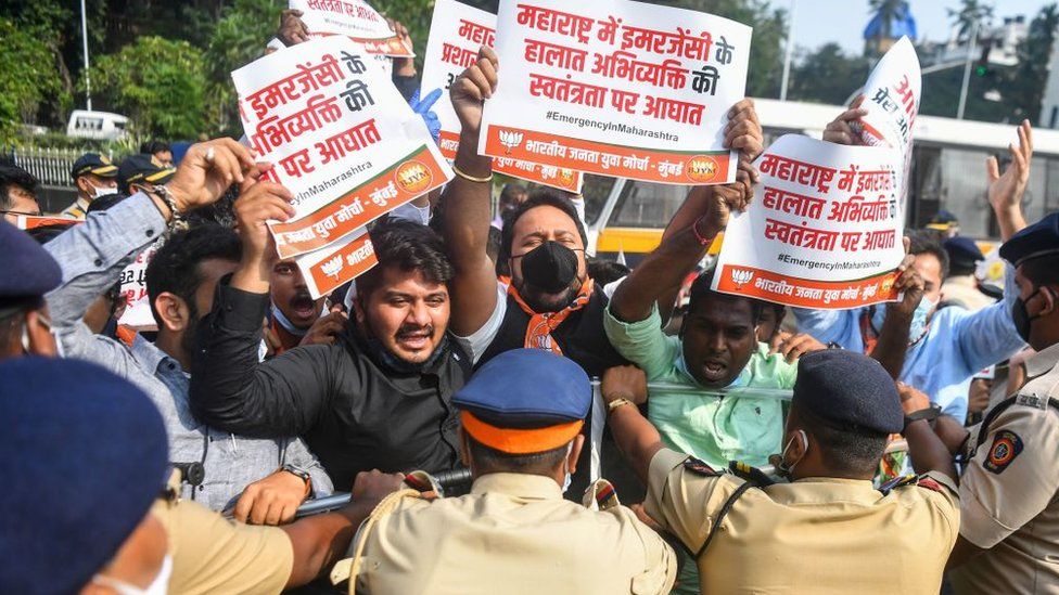Activists and supporters of Bharatiya Janata Party (BJP) hold placards as they scuffle with police during a protest.