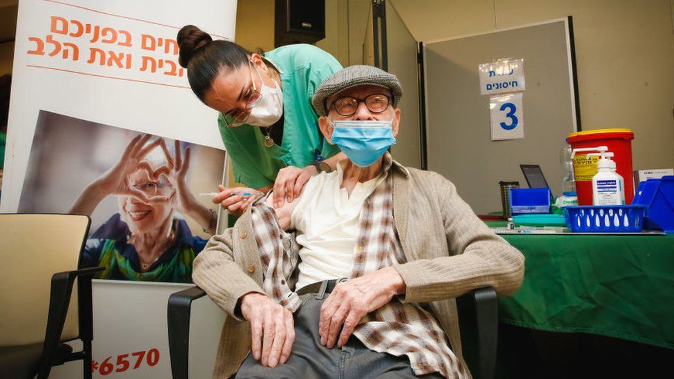 An elderly man being vaccinated