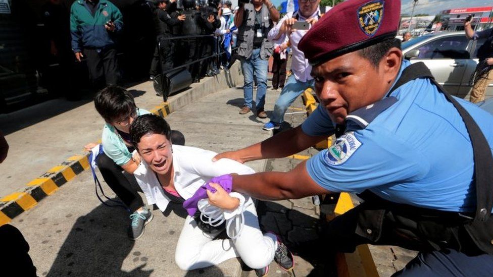 Riot police detain a protester during a march called "United for freedom" against Nicaraguan President Daniel Ortega in Managua