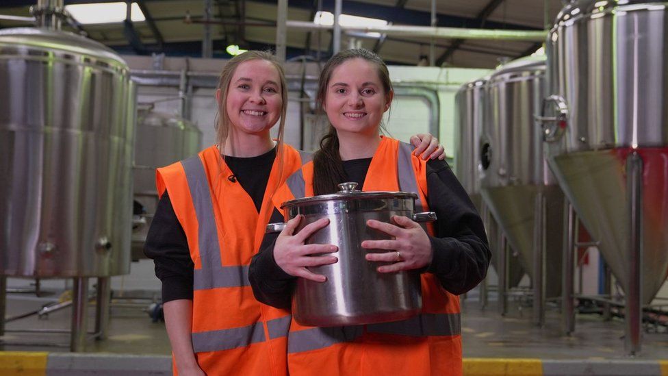 Joelle and Sarah holding what they brewed their first ever alcohol free beer in