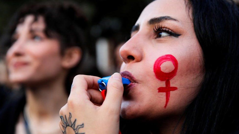A woman blows a whistle during a rally to mark International Women's Day in Istanbul, Turkey March 8, 2023