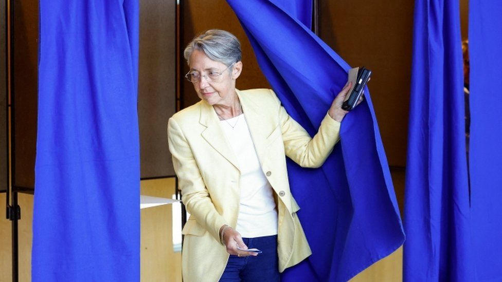 French Prime Minister Elisabeth Borne, candidate under the presidential majority "Ensemble", leaves a polling booth in the first round of French parliamentary elections, at a polling station in Vire-Normandie