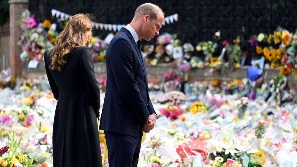 The Princess and Prince of Wales look at floral tributes outside Sandringham House in Norfolk