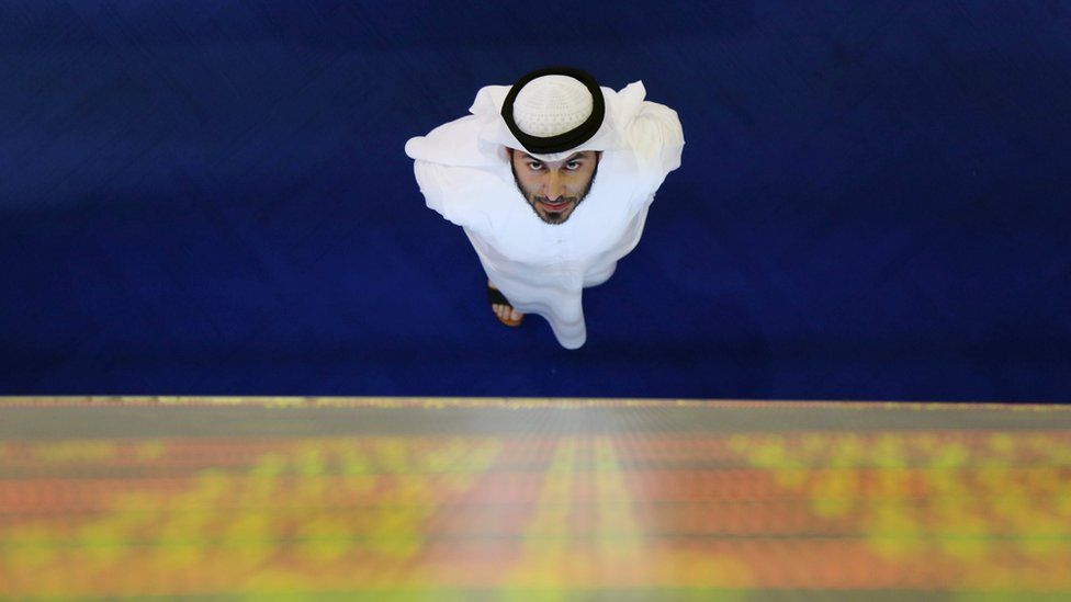 An investor looks at the screen at the Dubai International Financial Market in Dubai, UAE