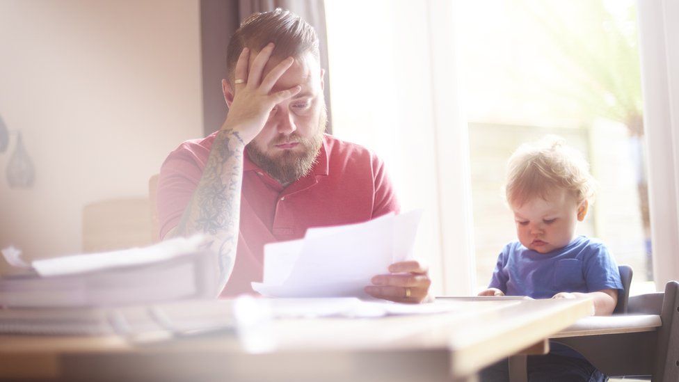 Father looking worried and son