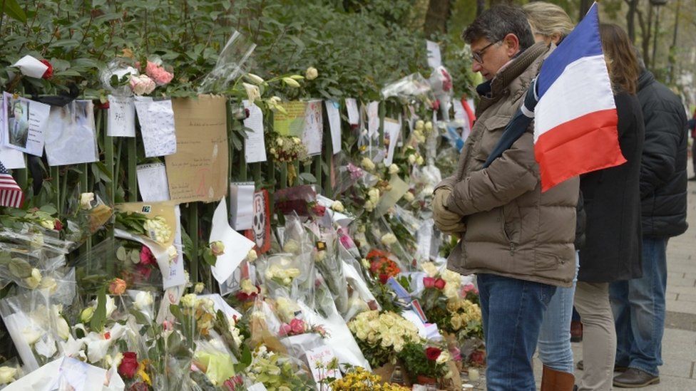 People attend the makeshift shrine for the Bataclan victims, 27 Nov