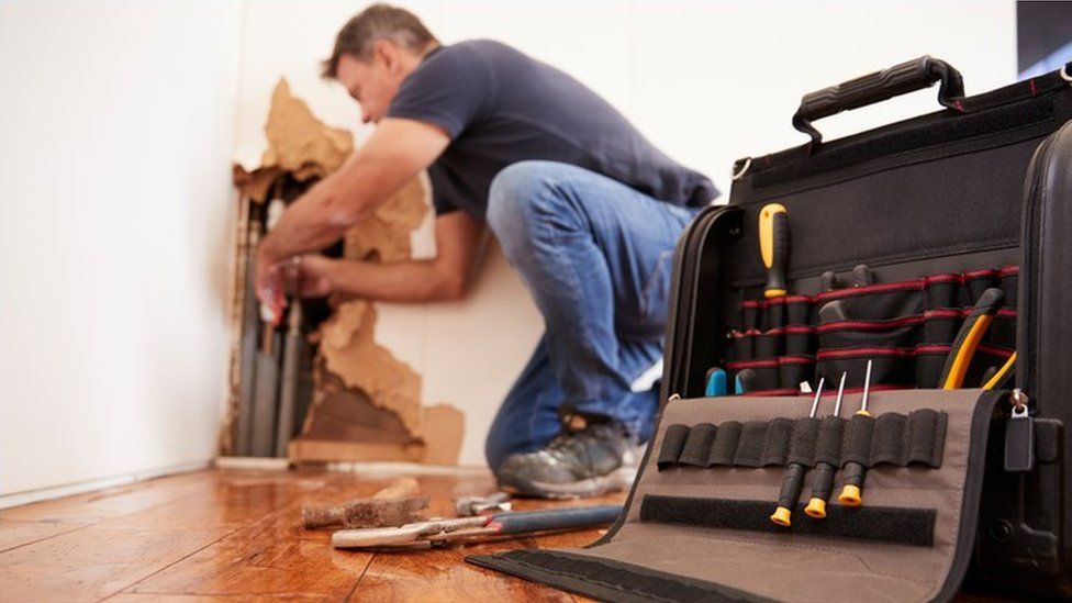 Man making repairs in home