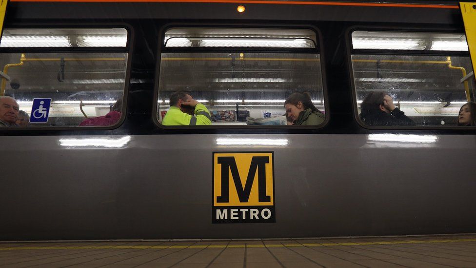People sit on the Metro