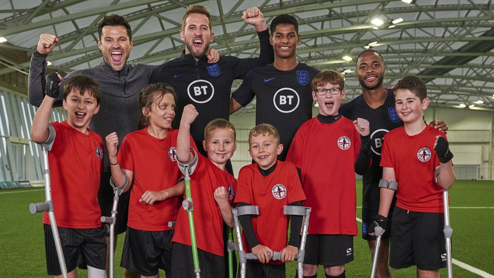 Children from the England Amputee Football Association with Mark Wright, Harry Kane, Marcus Rashford, Raheem Sterling