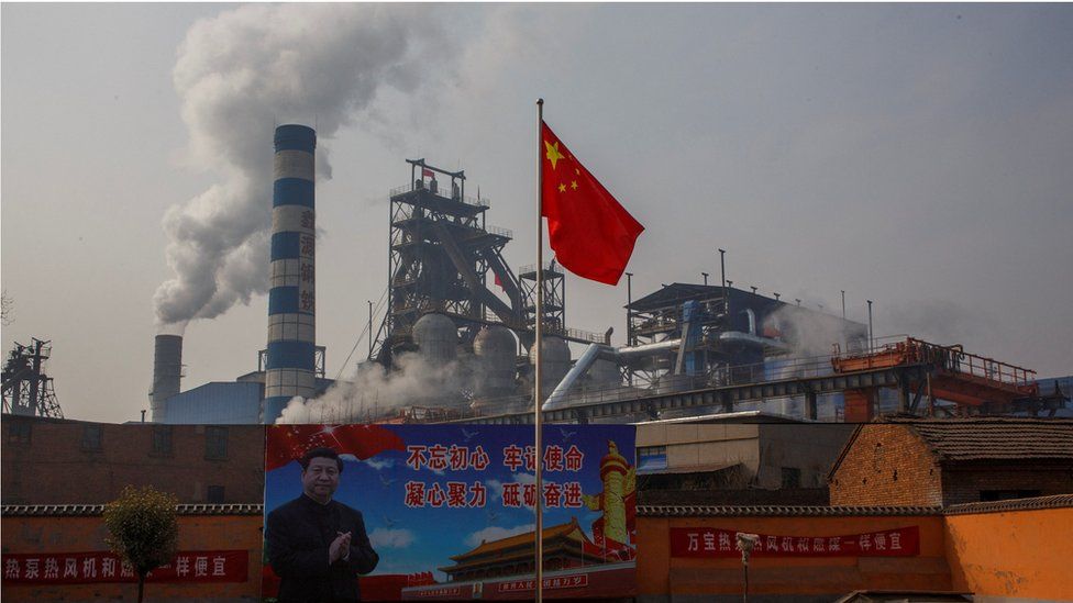 A poster showing Chinese President Xi Jinping is seen in front of the Xinyuan Steel plant in Anyang, Henan province, China, February