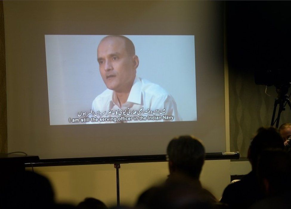 ) In this photograph taken on March 29, 2016, Pakistani journalists watch a video showing Indian national Kulbhushan Yadav, arrested on suspicion of spying, during a press conference in Islamabad