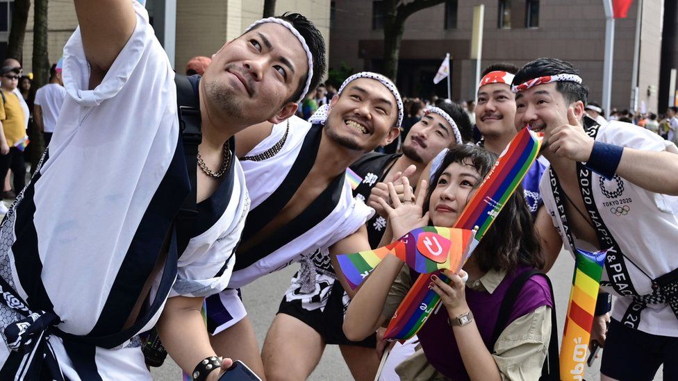 Participants pose for a selfie while taking part in the annual gay pride parade in Taipei