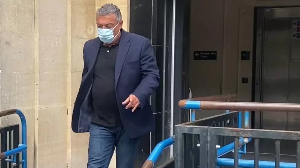 Man wearing a mask leaving court