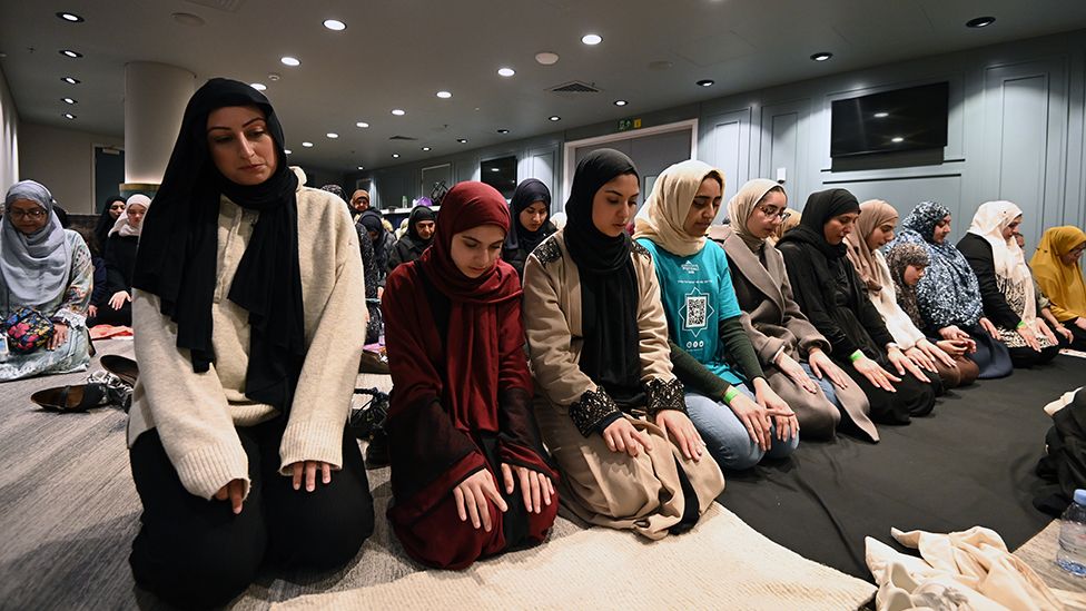 Women pray during an open Iftar at Wembley stadium to mark the final week of Ramadan on April 28, 2022 in London