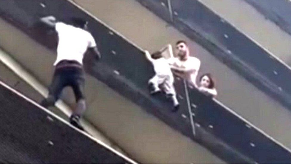 Mamoudou Gassama scales building to rescue child. 27 May 2018
