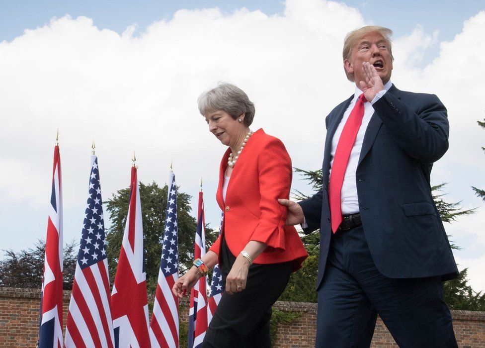 US President Donald Trump walks with Prime Minister Theresa May