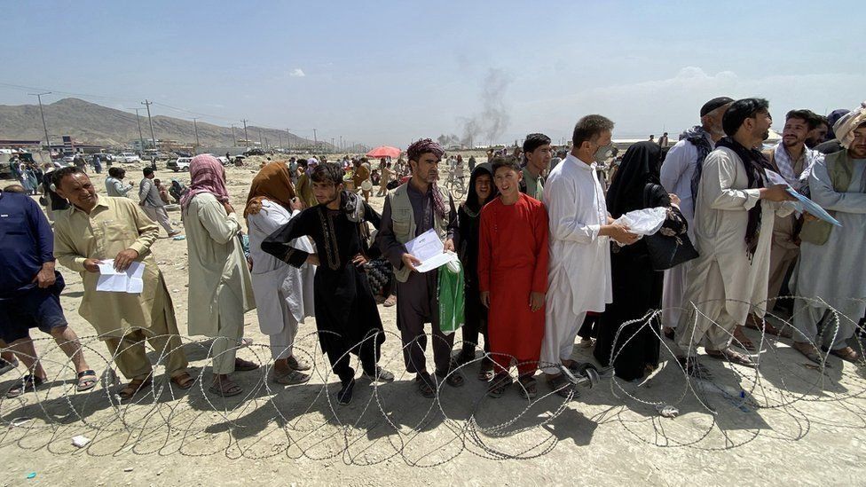 Afghan citizens standing outside Kabul Airport