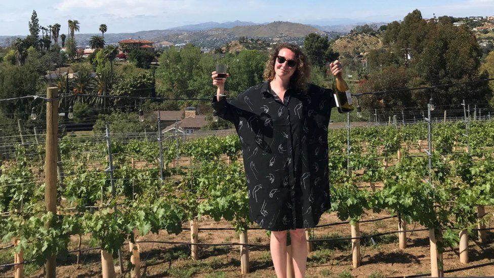 Meg Fozzard raising some bottles of wine on her family trip to California