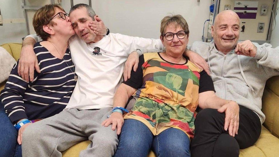 Photo uploaded to social media of Simon Marman and Louis Har being reunited with their families