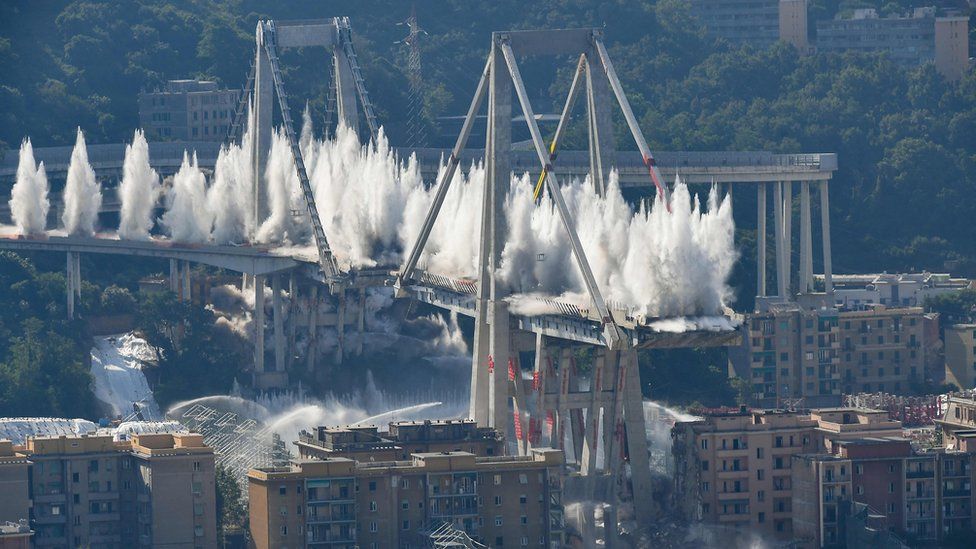 Explosive charges blow up the eastern pylons of Genoa"s Morandi motorway bridge on June 28, 2019 in Genoa