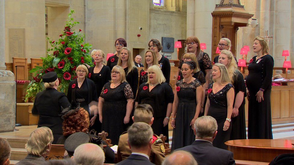 The Northern Ireland Military Wives Choir sings during the service