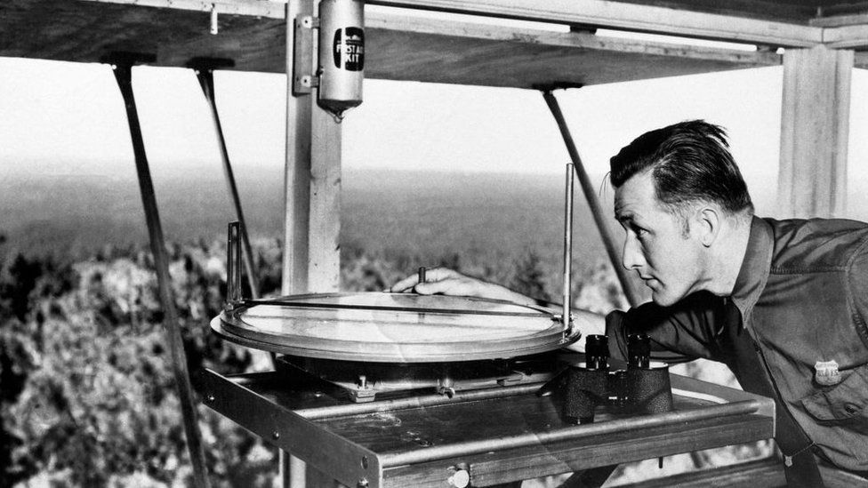 A lookout using an Osborne Fire Finder at a tower overlooking Coconino Nation Forest in 1941