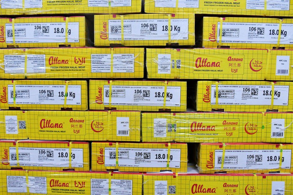 Boxes of packaged frozen buffalo meat stand inside a cold storage unit at a plant operated by Allana Group in Aligarh, Uttar Pradesh, India, on Tuesday, April 11, 2017.