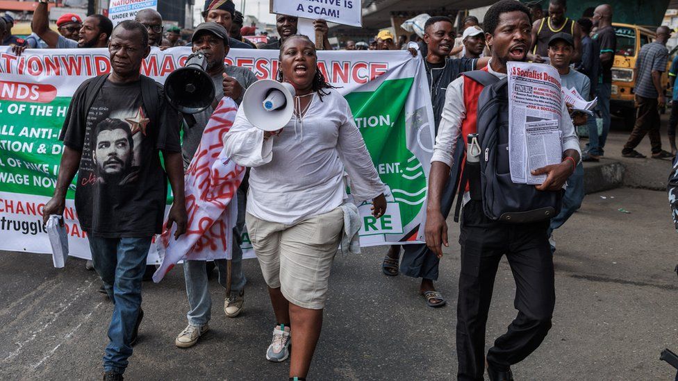 Protesters march with placards and banners during the Joint Action Front (JAF) and the Coalition for Revolution (CORE) nationwide protest against the government policies of Nigerian President Bola Tinubu in Lagos on February 26, 2024