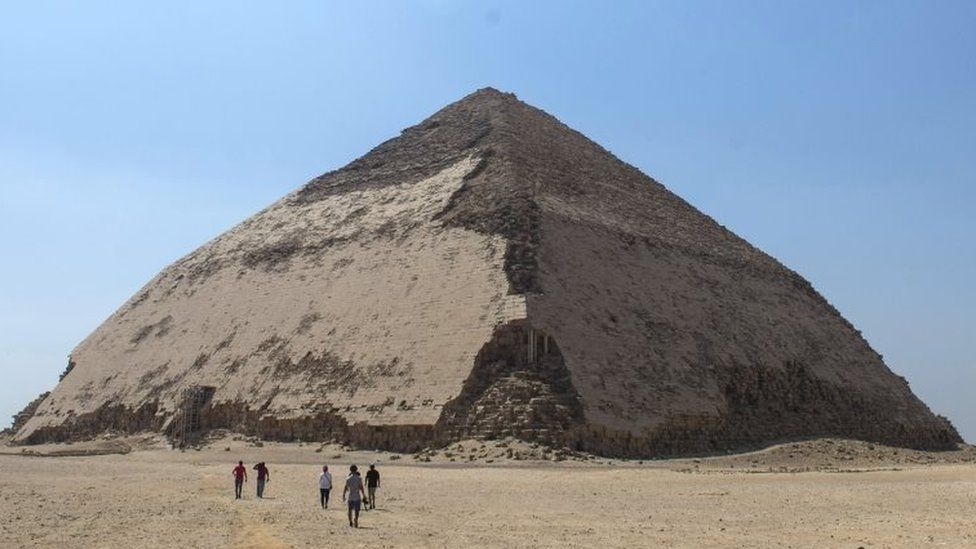 People walk in front of the Bent Pyramid. Photo: 13 July 2019
