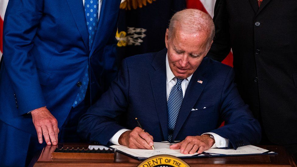 US President Joe Biden signs into law the Inflation Reduction Act of 2022 in the State Dining Room of the White House on Tuesday August 16, 2022.