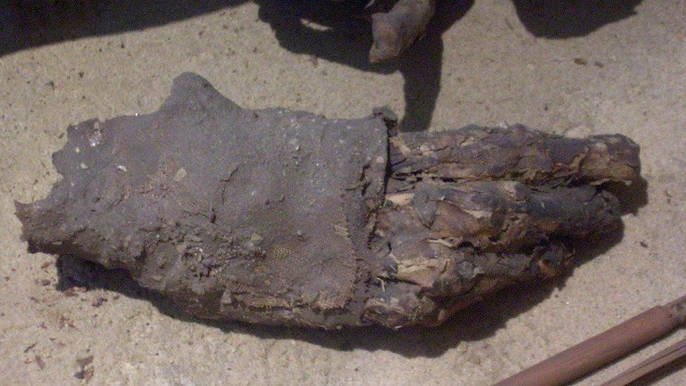 Ancient mummy's hand wrapped in fabric