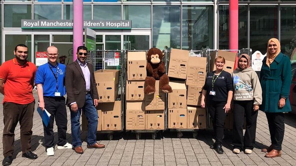 staff and volunteers with cardboard boxes