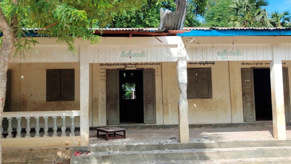 The exterior of the school after the attack shows debris and damaged columns