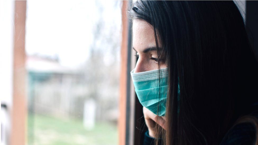 Woman looks through a window