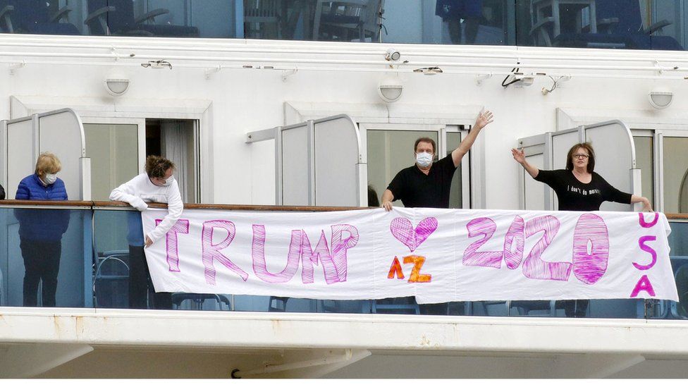 Passengers display a banner reading "Trump 2020" on the deck of the cruise ship Diamond Princess, 14 February 2020