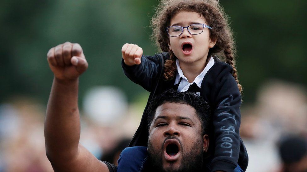 Demonstrators react during a Black Lives Matter protest in Verulamium Park, St Albans