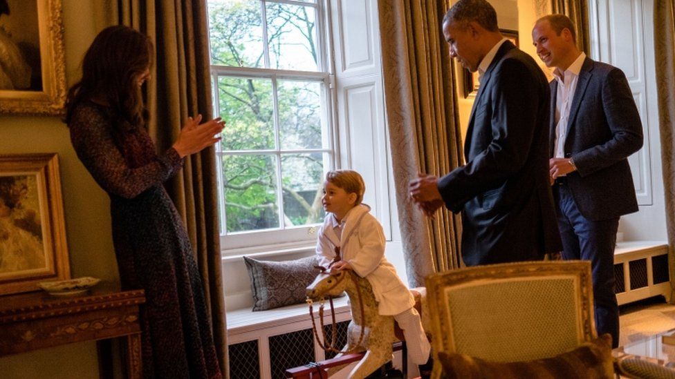 Prince George on a rocking horse with his parents the Duke and Duchess of Cambridge and US President Barack Obama