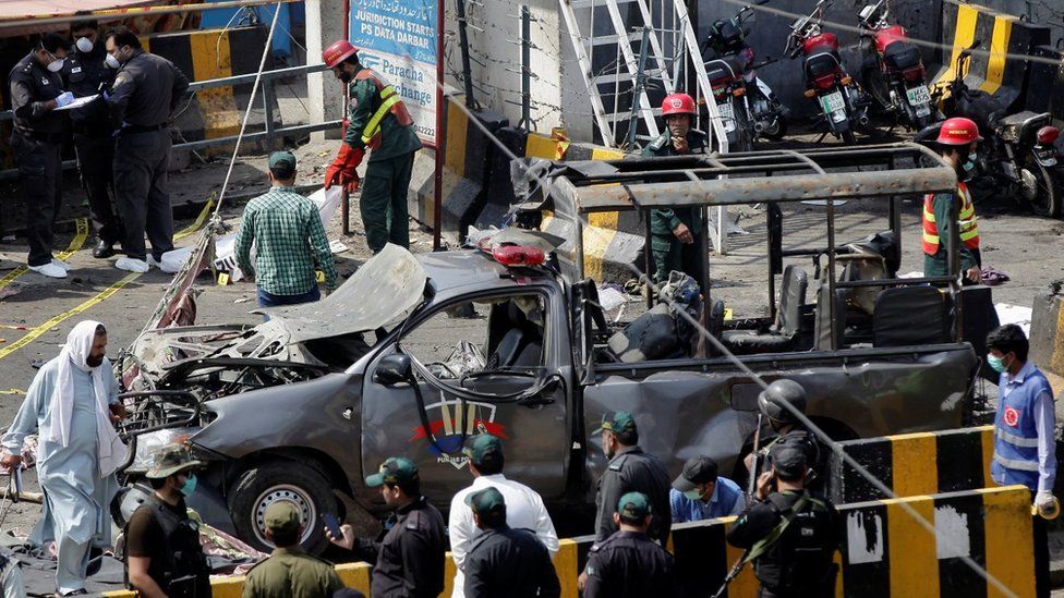 Burnt-out vehicle at the site of the bomb blast in Lahore