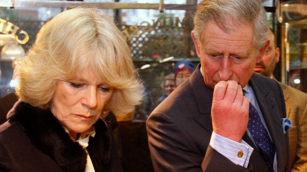 Camilla, Duchess of Cornwall and Prince Charles taste some cheese during a visit to cheese shop Paxton & and Whitfield
